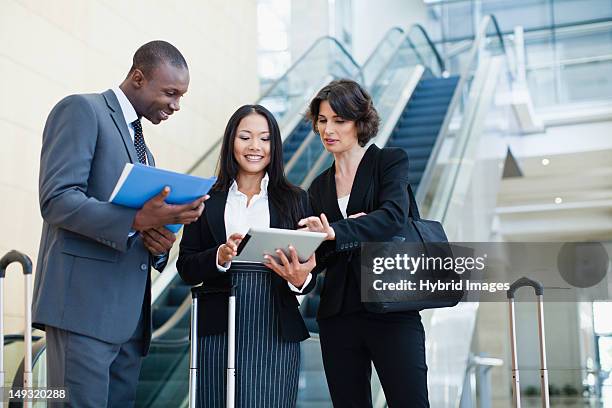 business people talking in lobby - airport authority stock pictures, royalty-free photos & images