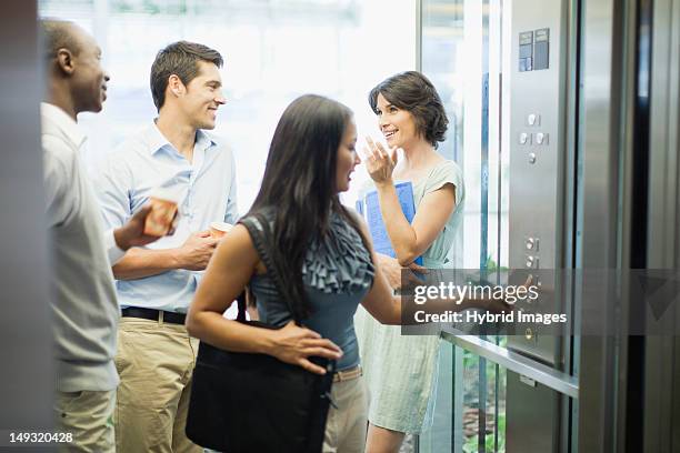 business people riding glass elevator - lift button stock pictures, royalty-free photos & images