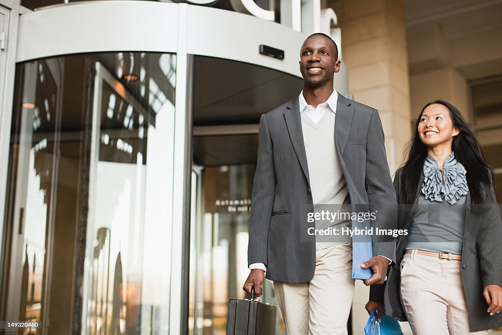 Business people walking outside building