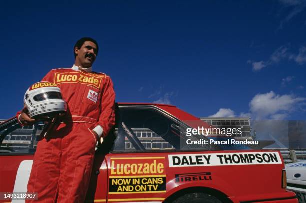 Olympic and World Champion Decathlete Daley Thompson from Great Britain stands beside the Lucozade Ford Escort RS Turbo before the Production Saloon...