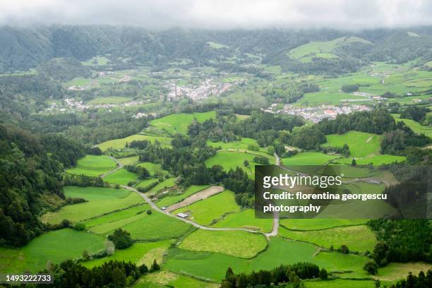 vale das furnas (furnas valley) and the village of furnas sitting in the huge caldera from pico do ferro viewpoint, furnas, sao miguel island, azores, portugal - furnas valley stock pictures, royalty-free photos & images