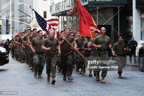 Members of the Marine Corps run past the New York Stock Exchange during Fleet Week in the city on May 25, 2023 in New York City. Nine ships,...