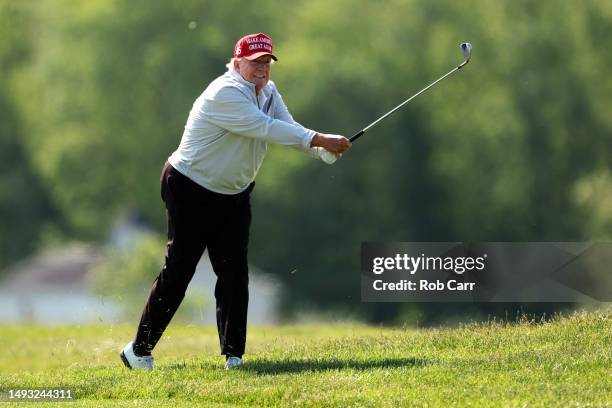 Former President Donald Trump follows his second shot during the pro-am prior to the LIV Golf Invitational - DC at Trump National Golf Club on May...