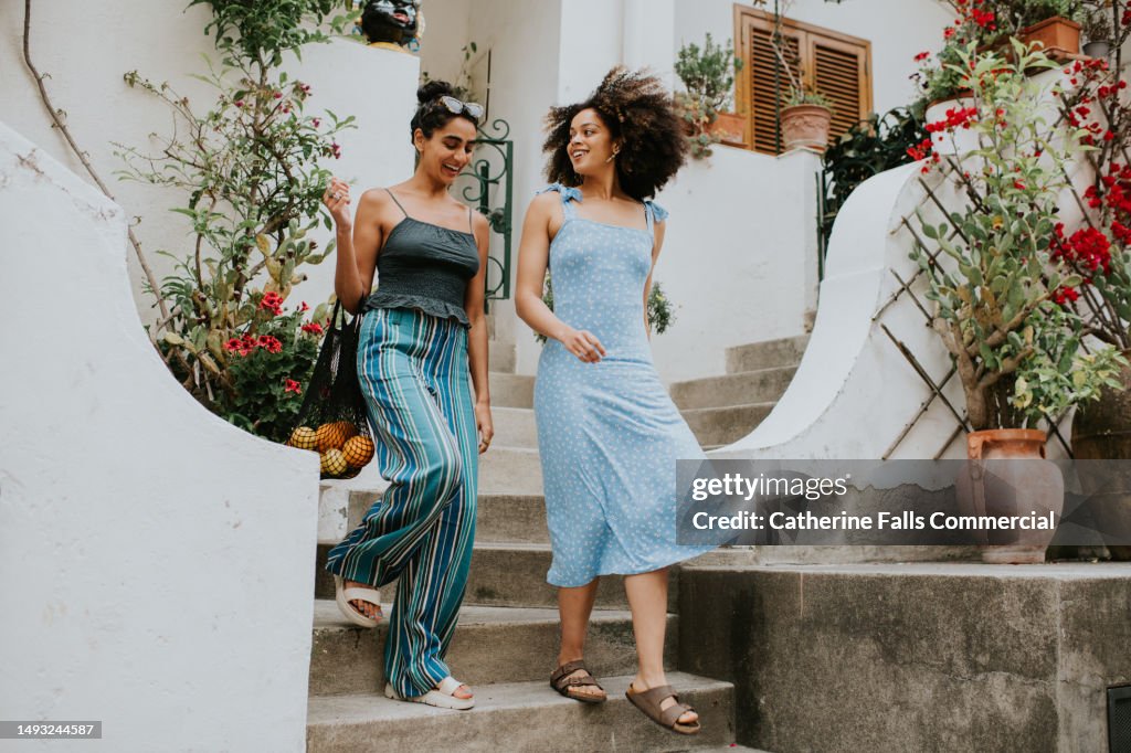 Two young woman leave a holiday villa