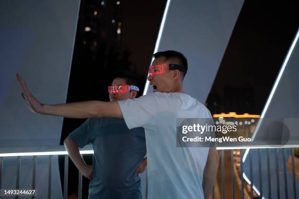 man using glowing glasses for gaming experience and virtual reality concept - virtual stock pictures, royalty-free photos & images