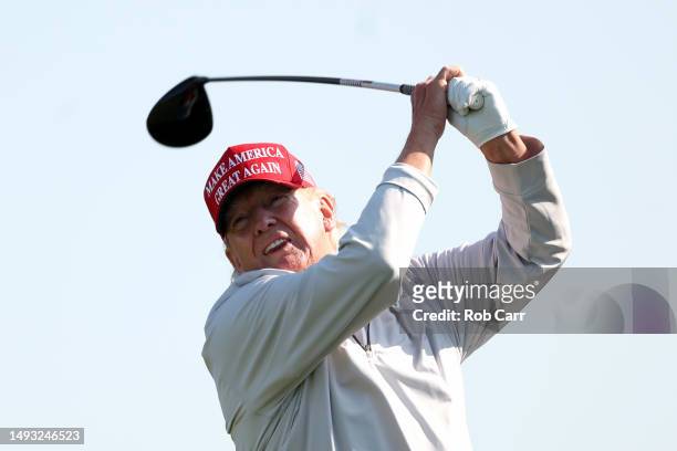 Former President Donald Trump follows his tee shot during the pro-am prior to the LIV Golf Invitational - DC at Trump National Golf Club on May 25,...