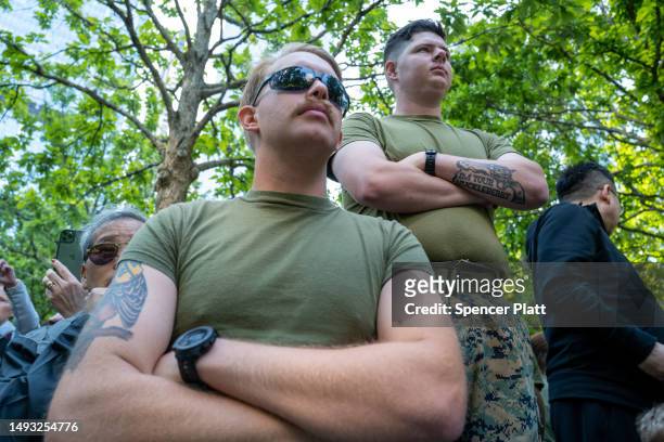 Marines watch as members of the Marine Corps Silent Drill Platoon participate in a morning performance at Ground Zero during Fleet Week in Manhattan...