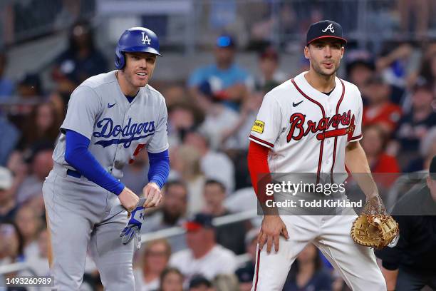 Freddie Freeman of the Los Angeles Dodgers has a laugh with Matt Olson of the Atlanta Braves at first base during the ninth inning at Truist Park on...