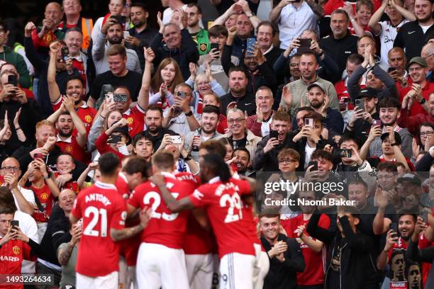 Fans of Manchester United celebrate their side's first goal scored by Casemiro of Manchester United during the Premier League match between...