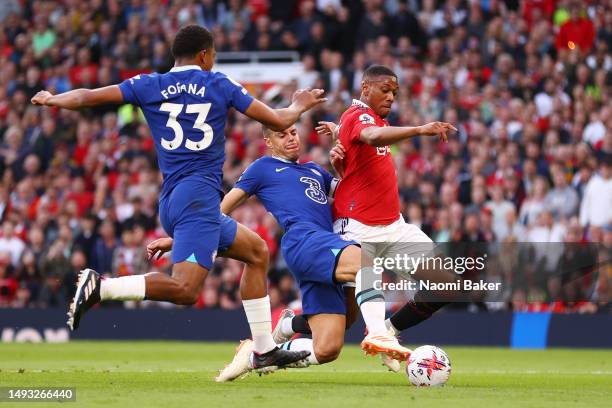 Anthony Martial of Manchester United is challenged by Cesar Azpilicueta and Wesley Fofana of Chelsea during the Premier League match between...