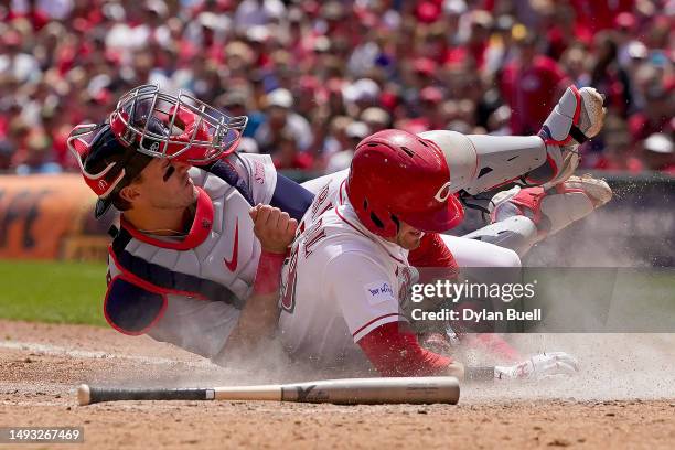 Andrew Knizner of the St. Louis Cardinals tags out TJ Friedl of the Cincinnati Reds at home plate in the sixth inning at Great American Ball Park on...