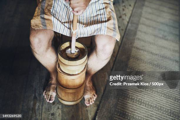 man making butter with butter churn old traditional method making of butter,poland - butter churn stock pictures, royalty-free photos & images