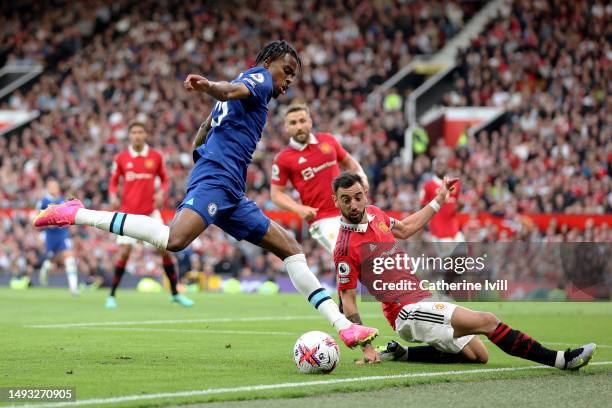 Carney Chukwuemeka of Chelsea is challenged by Bruno Fernandes of Manchester United during the Premier League match between Manchester United and...