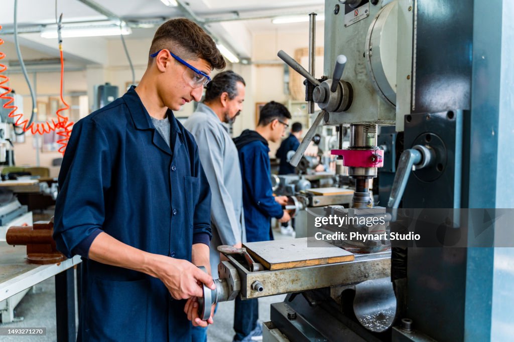 Group of young people in technical vocational training with teacher