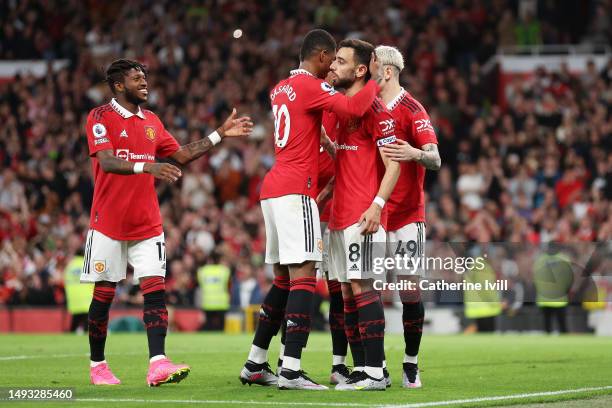 Bruno Fernandes of Manchester United celebrates with Fred and Marcus Rashford after scoring the team's third goal during the Premier League match...
