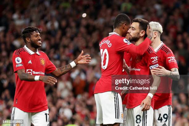 Bruno Fernandes of Manchester United celebrates with Fred and Marcus Rashford after scoring the team's third goal during the Premier League match...