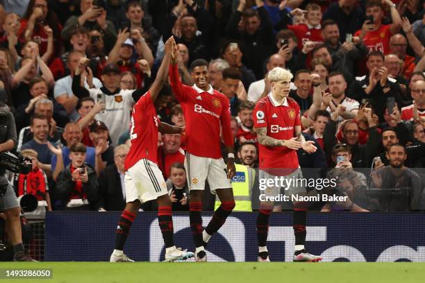 Marcus Rashford of Manchester United celebrates with team mates after scoring the team's fourth goal during the Premier League match between...