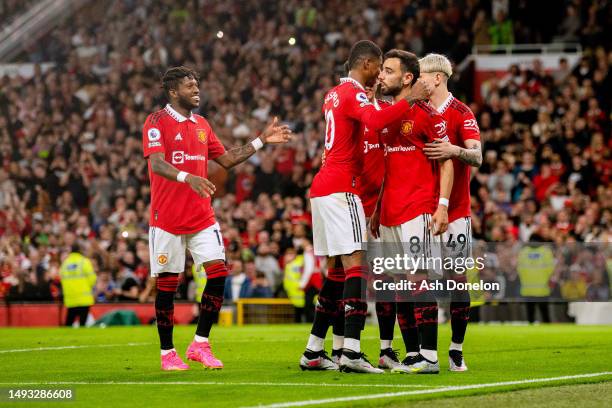 Bruno Fernandes of Manchester United celebrates with team mates after scoring their sides third goal from the penalty spot during the Premier League...