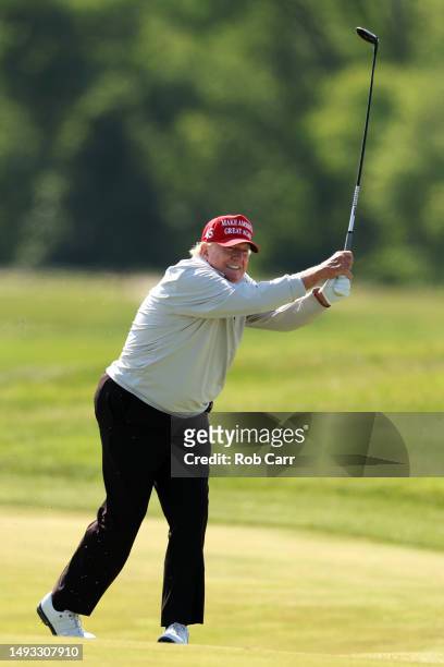 Former President Donald Trump follows his second shot during the pro-am prior to the LIV Golf Invitational - DC at Trump National Golf Club on May...