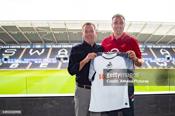Swansea City's chairman Andy Coleman and Swansea's new head coach Michael Duff hold up a shirt during the Swansea City AFC press conference at the...