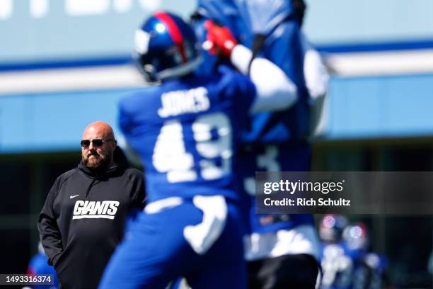 Head coach Brian Daboll of the New York Giants looks on as tight end Ryan Jones battles wide receiver David Sills V during the teams OTAs at Quest...