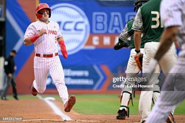 Cannon Peebles of the NC State Wolfpack crosses home plate against the Miami Hurricanes in the first inning during the ACC Baseball Championship at...