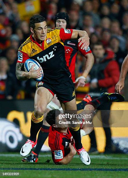 Dan Carter of the Crusaders misses the tackle of Sonny Bill Williams of the Chiefs during the Super Rugby Semi Final match between the Chiefs and...