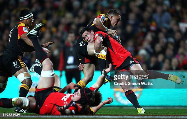 Aaron Cruden of the Chiefs is tackled by Ryan Crotty of the Crusaders during the Super Rugby Semi Final match between the Chiefs and Crusaders at...