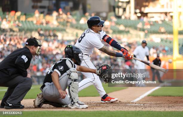 Javier Baez of the Detroit Tigers hits a RBI single in the fourth inning in front of Seby Zavala of the Chicago White Sox at Comerica Park on May 25,...