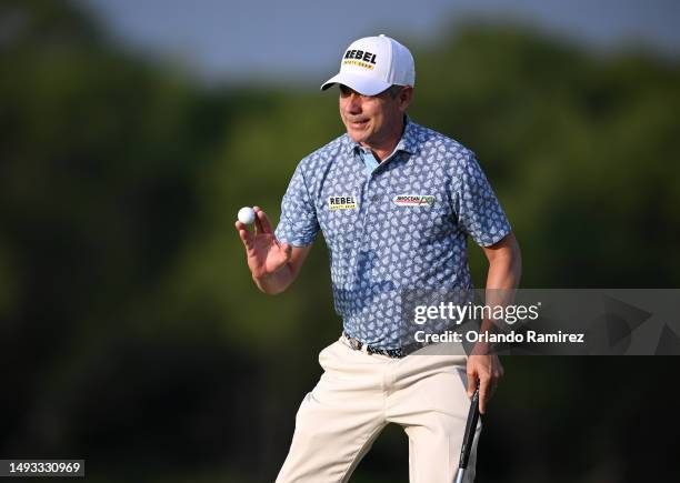 Adilson da Silva of Brazil acknowledges the crowd after a putt on the 17th green during the first round of the KitchenAid Senior PGA Championship at...