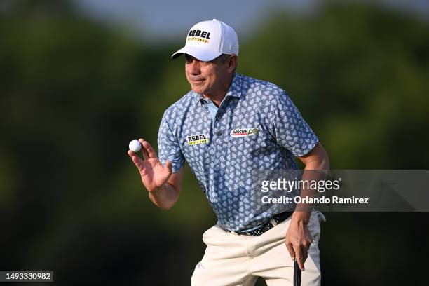 Adilson da Silva of Brazil acknowledges the crowd after a putt on the 17th green during the first round of the KitchenAid Senior PGA Championship at...