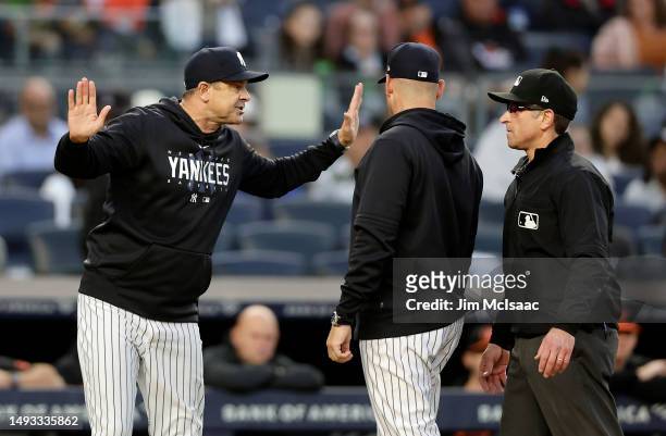Manager Aaron Boone of the New York Yankees argues with first base umpire Chris Guccione after he was ejected from a game against the Baltimore...