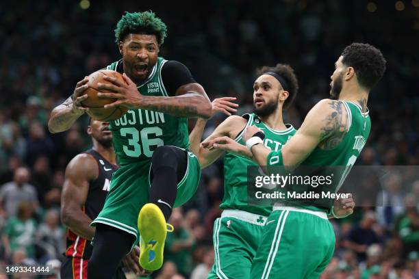 Marcus Smart of the Boston Celtics grabs a rebound ahead of Jimmy Butler of the Miami Heat during the first quarter in game five of the Eastern...