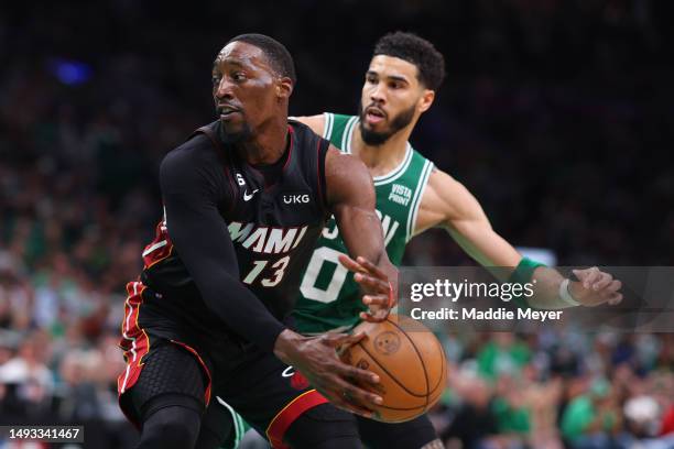 Bam Adebayo of the Miami Heat controls the ball ahead of Jayson Tatum of the Boston Celtics during the first quarter in game five of the Eastern...