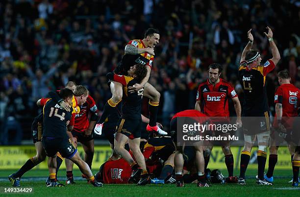 Sonny Bill Williams of the Chiefs leaps on Tawera Kerr-Barlow of the Chiefs in celebration during the Super Rugby Semi Final match between the Chiefs...