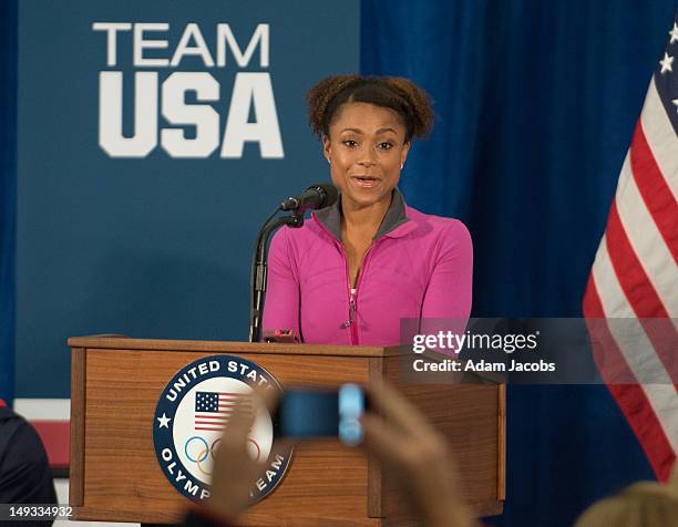 Retired gymnast Dominique Dawes introduces First Lady Michelle Obama at the University of East London on July 27, 2012 in London, England. Michelle...