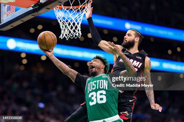 Marcus Smart of the Boston Celtics drives to the net ahead of Caleb Martin of the Miami Heat during the third quarter in game five of the Eastern...