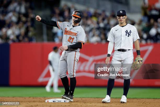 Austin Hays of the Baltimore Orioles reacts at second base next to Anthony Volpe of the New York Yankees after his eighth inning two run double at...