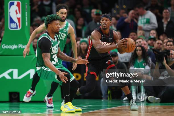 Jimmy Butler of the Miami Heat controls the ball ahead of Marcus Smart of the Boston Celtics during the third quarter in game five of the Eastern...