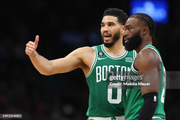 Jayson Tatum talks with Jaylen Brown of the Boston Celtics against the Miami Heat during the fourth quarter in game five of the Eastern Conference...