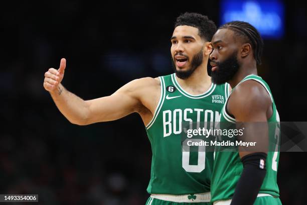 Jayson Tatum talks with Jaylen Brown of the Boston Celtics against the Miami Heat during the fourth quarter in game five of the Eastern Conference...