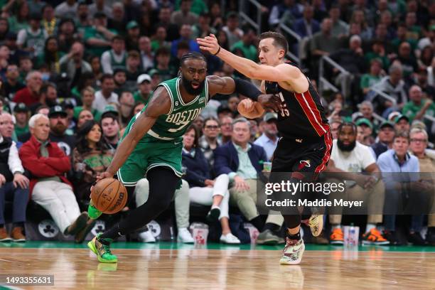 Jaylen Brown of the Boston Celtics controls the ball ahead of Duncan Robinson of the Miami Heat during the fourth quarter in game five of the Eastern...