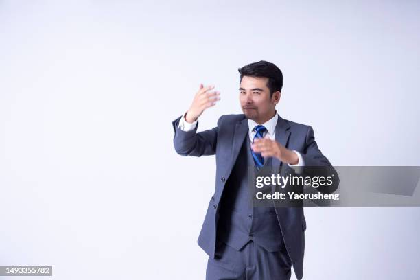 portrait of a confident  asian successful businessman against white background - pudong stock pictures, royalty-free photos & images