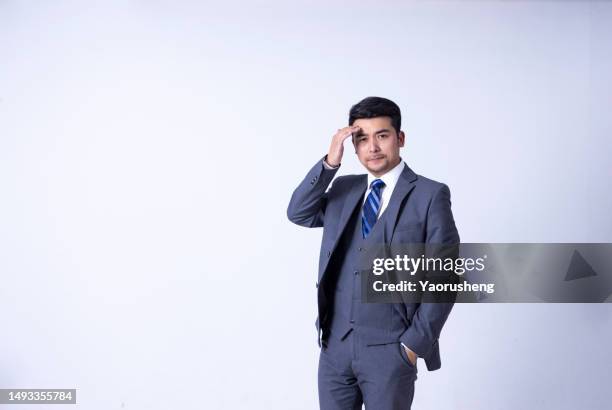 portrait of a confident  asian successful businessman against white background - pudong stock pictures, royalty-free photos & images