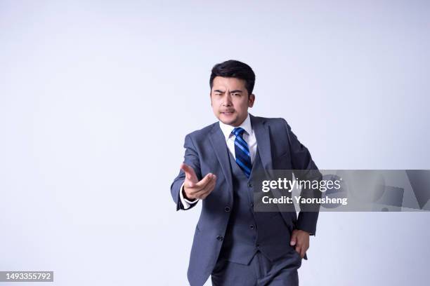 portrait of a confident  asian successful businessman against white background - pudong stock pictures, royalty-free photos & images