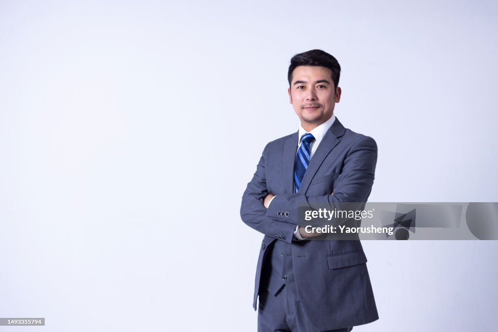 Portrait of a Confident Asian Successful Businessman against White Background