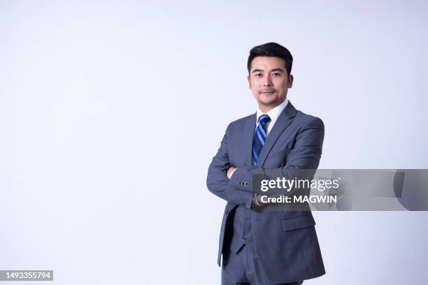 portrait of a confident asian successful businessman against white background - fato imagens e fotografias de stock