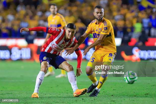 Ronaldo Cisneros of Chivas fights for the ball with Rafael Carioca of Tigres during the final first leg match between Tigres UANL and Chivas as part...