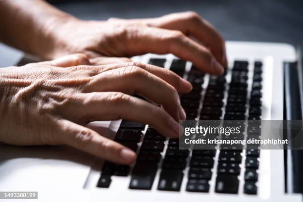 hacker ,a man using a laptop computer - technofobie stockfoto's en -beelden