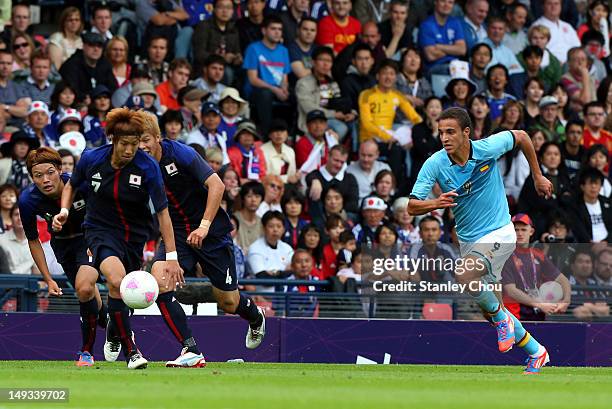 Yuki Otsu is pursued by Rodrgo of Spain during the Men's Football first round Group D Match of the London 2012 Olympic Games between Spain and Japan...